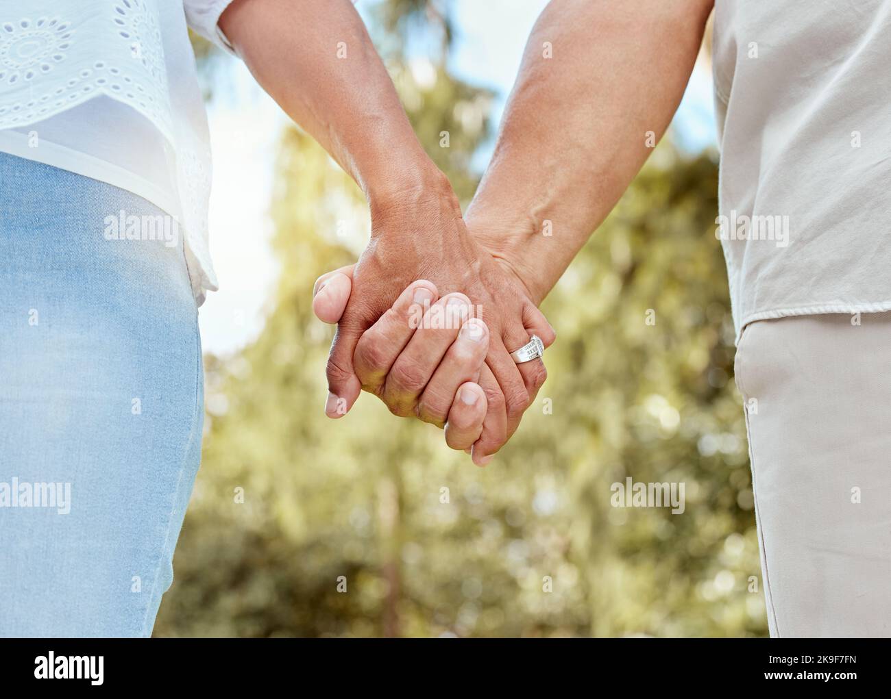 Marriage, support and hands of retirement couple in nature together for wellness, care and love. Elderly, pension and married people in garden for Stock Photo