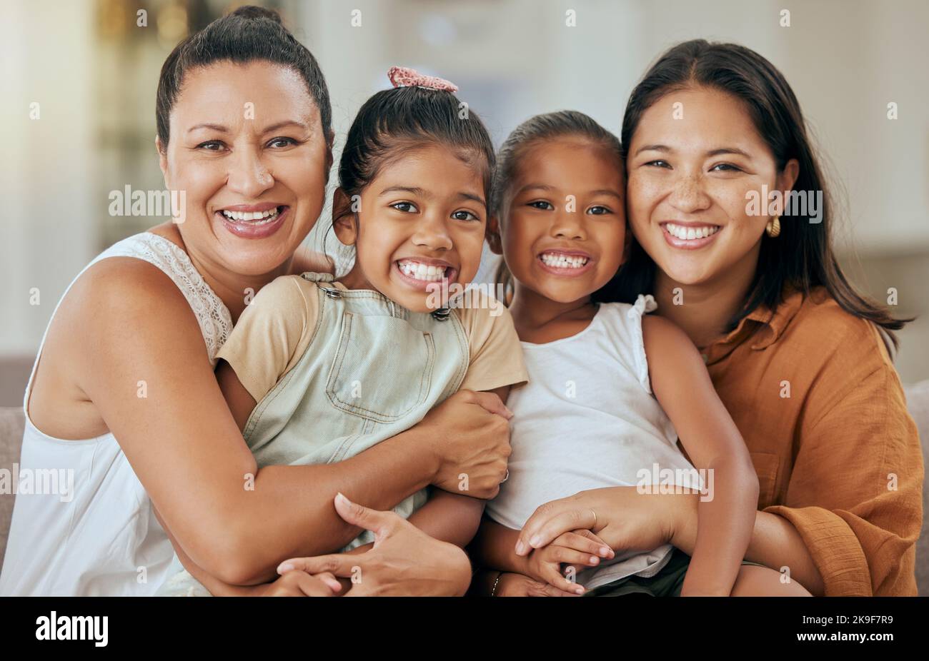 Women, family and smile of children, mother and grandmother together on living room sofa for love, support and happiness. Portrait of kids and Stock Photo