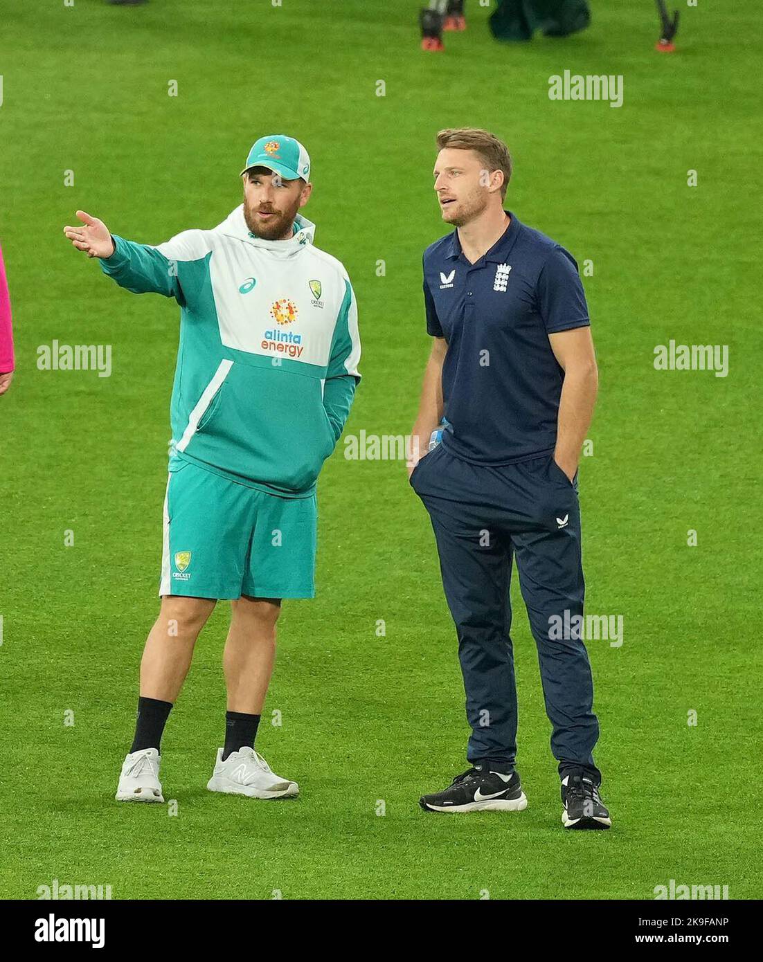 Australia's Aaron Finch (left) and England's Jos Buttler talk after the umpires inspected the outfield ahead of the T20 World Cup Super 12 match at Melbourne Cricket Ground in Melbourne, Australia. Picture date: Friday October 28, 2022. Stock Photo