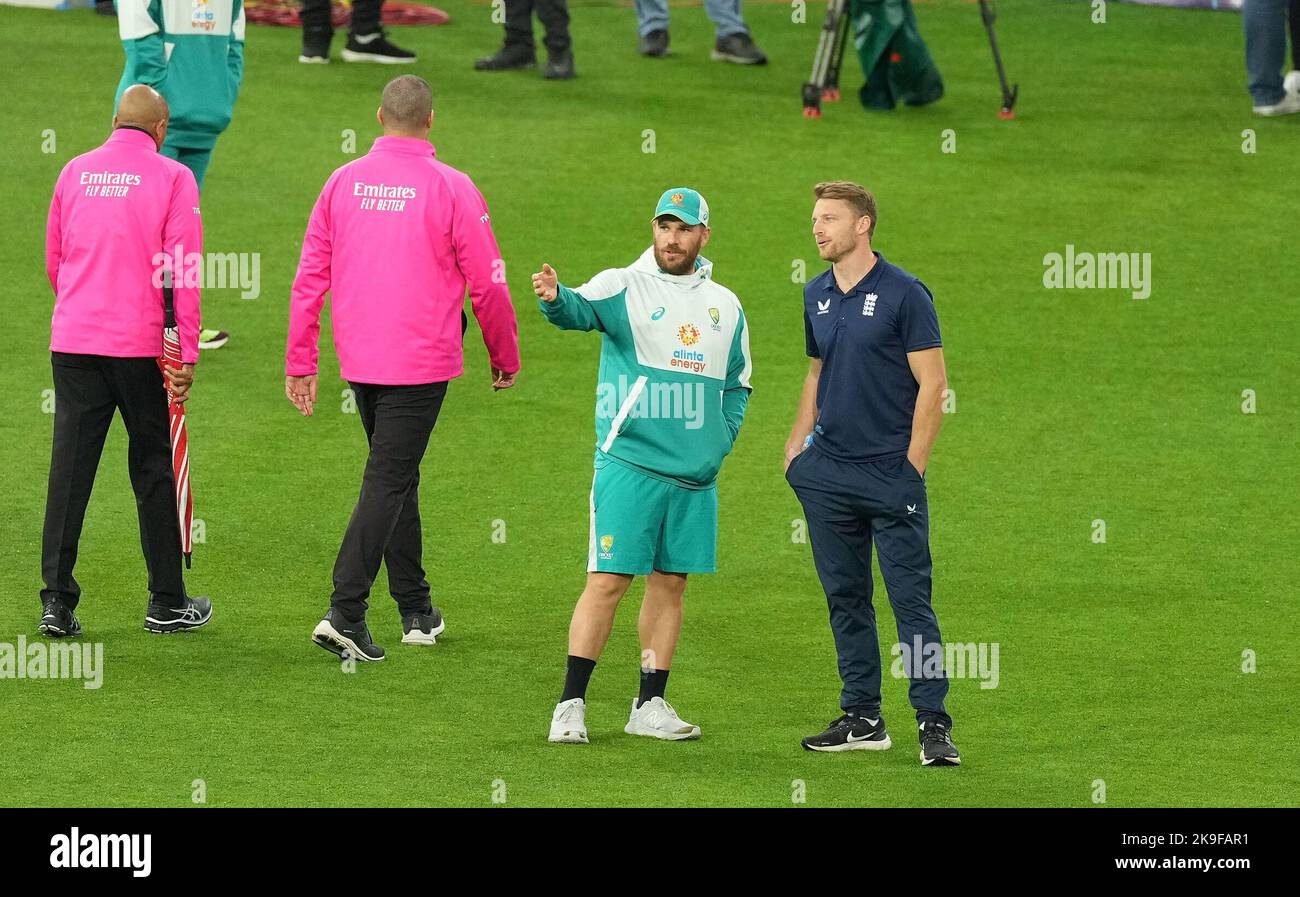 Australia's Aaron Finch (left) and England's Jos Buttler talk after the umpires inspected the outfield ahead of the T20 World Cup Super 12 match at Melbourne Cricket Ground in Melbourne, Australia. Picture date: Friday October 28, 2022. Stock Photo