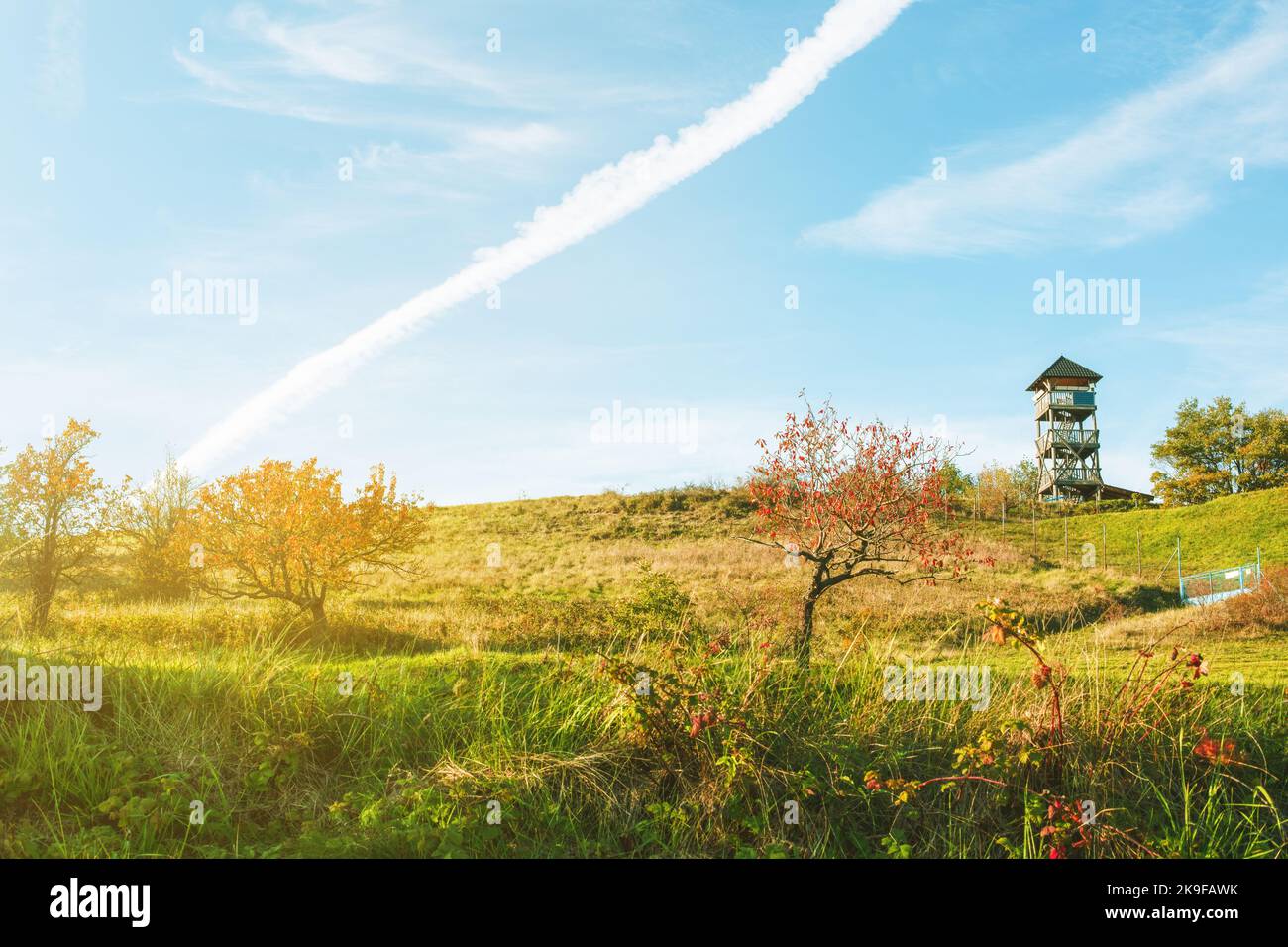 Watchtower on the green meadow on a sunny day.Autumn landscape. Stock Photo