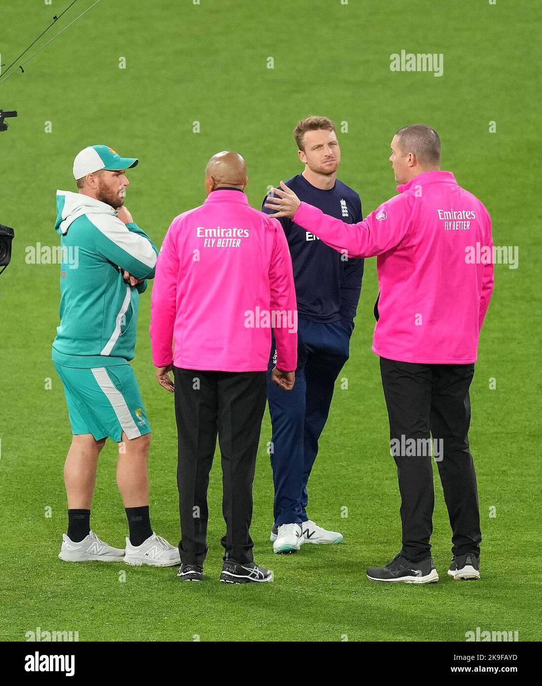 Umpires Chris Brown and Joel Wilson talk with Australia's Aaron Finch and England's Jos Buttler after the umpires inspected the outfield ahead of the T20 World Cup Super 12 match at Melbourne Cricket Ground in Melbourne, Australia. Picture date: Friday October 28, 2022. Stock Photo
