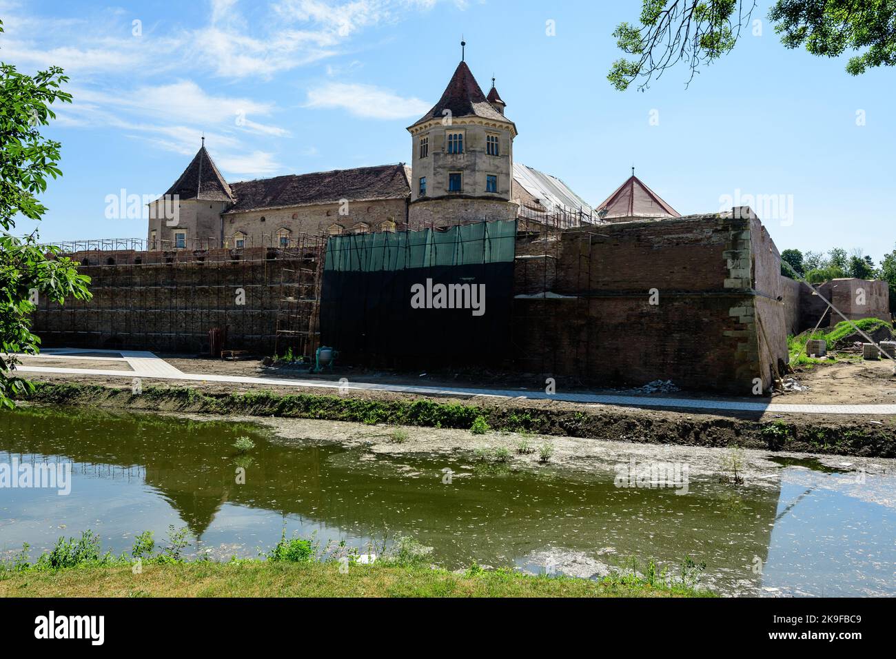 Renovated old historical buildings  of Fagaras Fortress (Cetatea Fagaras) during renovation works in a sunny summer day, in Transylvania (Transilvania Stock Photo