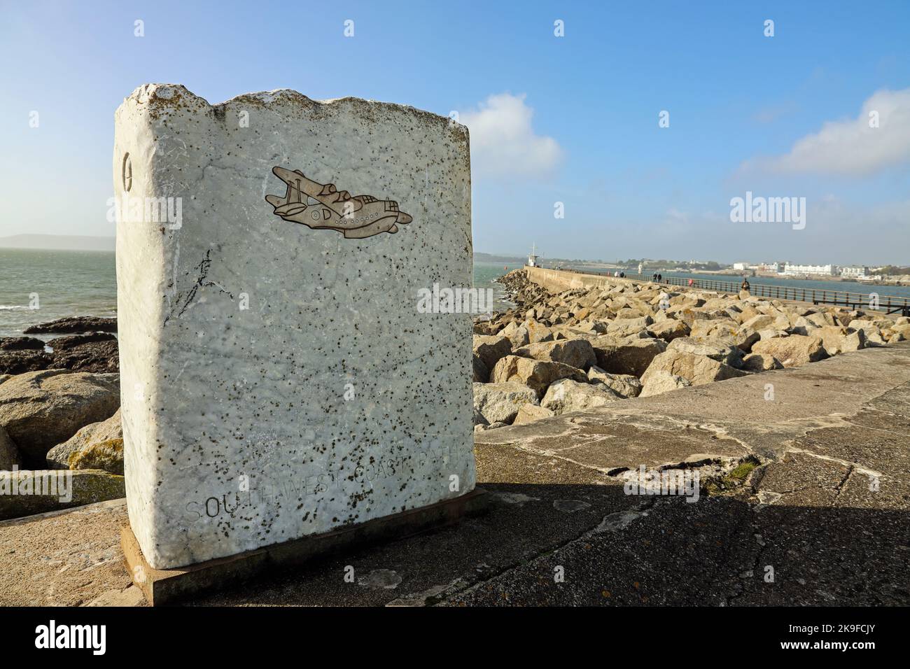 An acorn on a granite slab carved with a seaplane on the South West Coast Path at Mount Batten Breakwater in Plymouth, gives a nod to the days when it Stock Photo