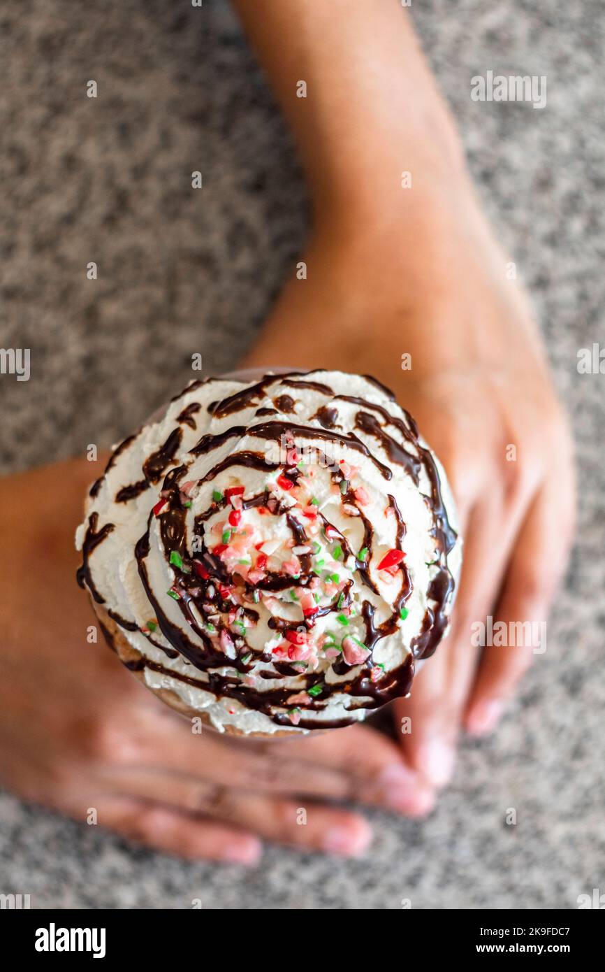 Ice blended coffee drink topped with sprinkles, chocolate syrup and whipped cream at a cafe in Cebu City, Philippines Stock Photo