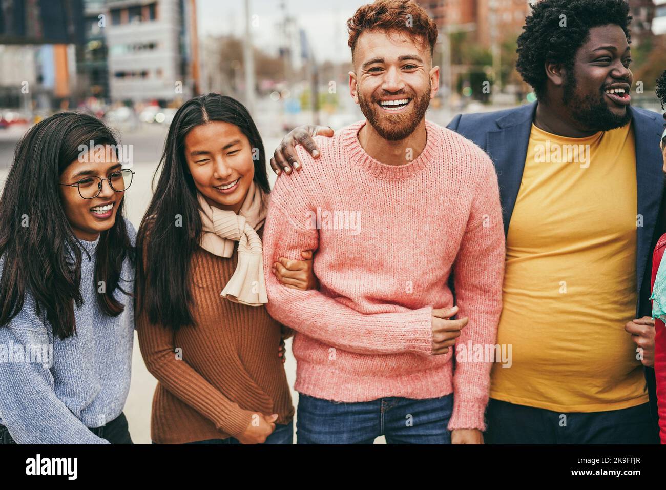 Young diverse people having fun outdoor laughing together - Focus on ...