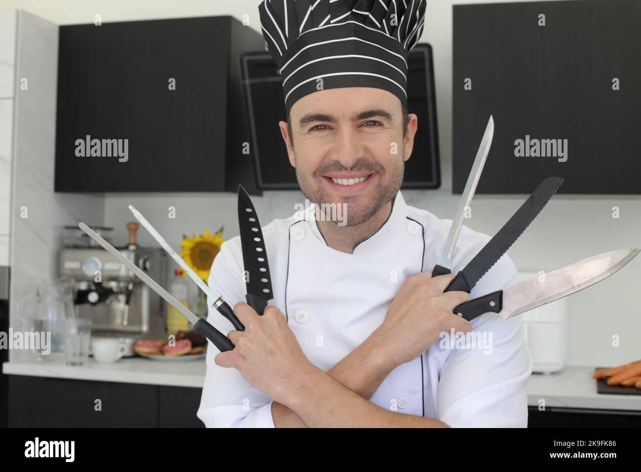 Chef holding a bunch of knives Stock Photo