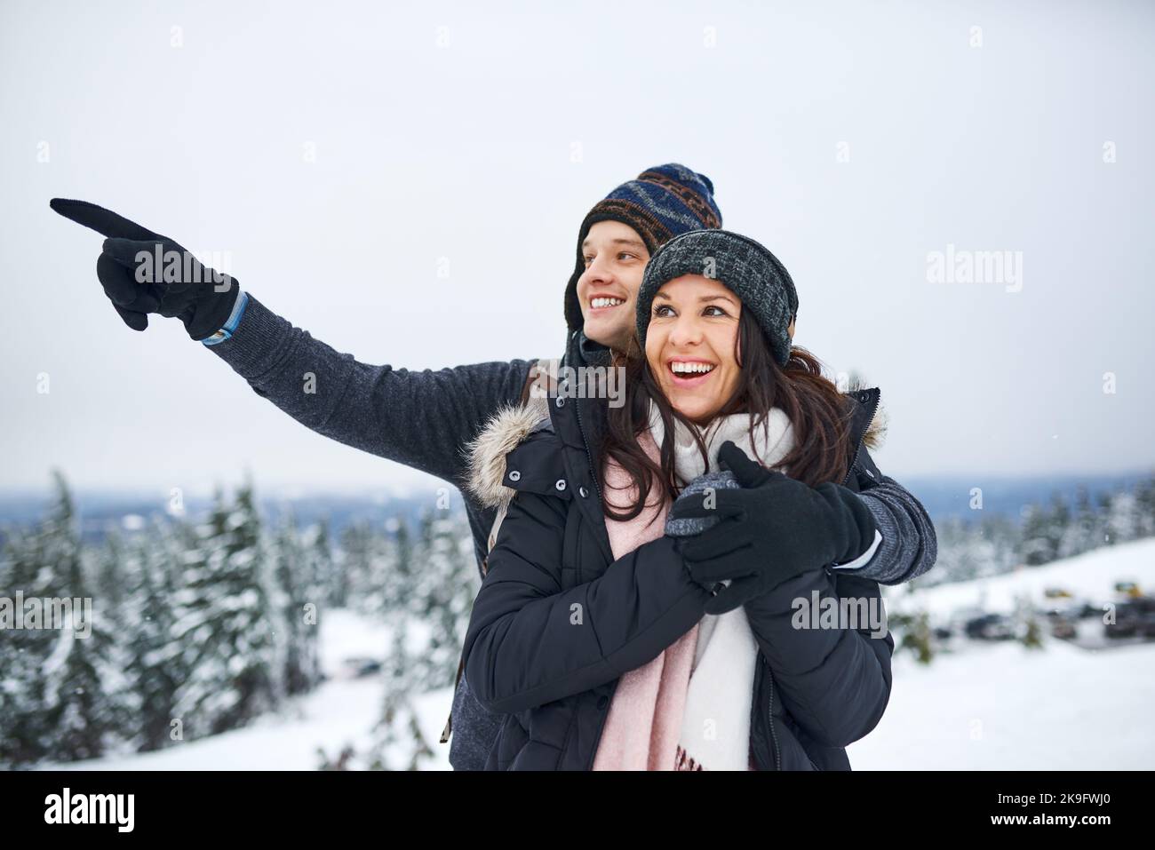 Everything is magical when it snows. a happy young couple enjoying themselves while being out in the snow. Stock Photo
