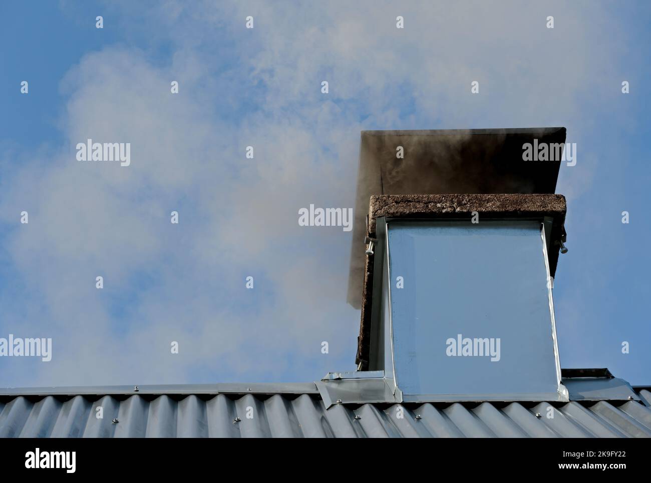 Smoke comes from the chimney Stock Photo