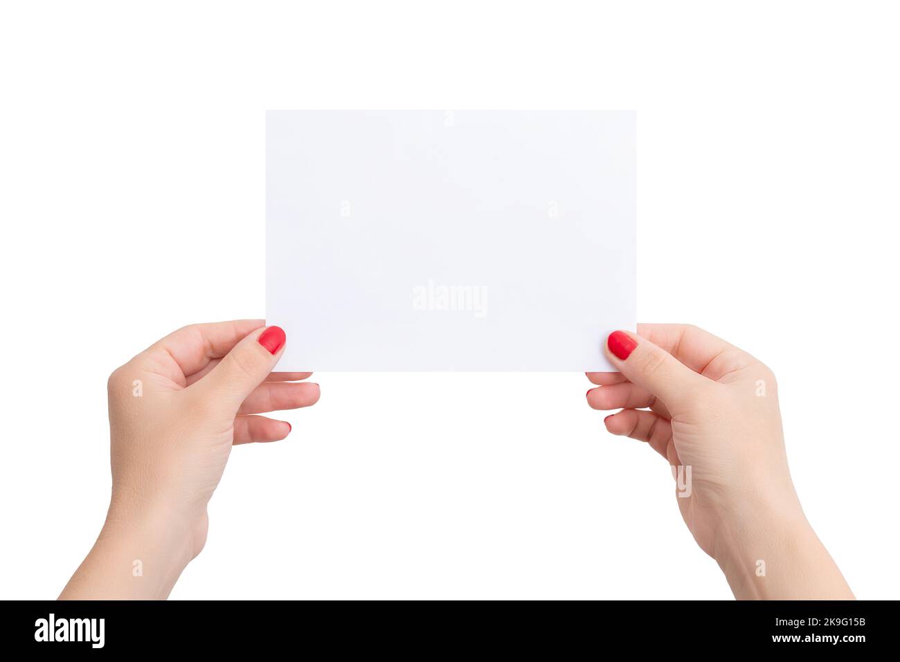 White A6 paper in woman's hands. Horizontal position. Blank sheet for copy presentation. Isolated bacgkround Stock Photo