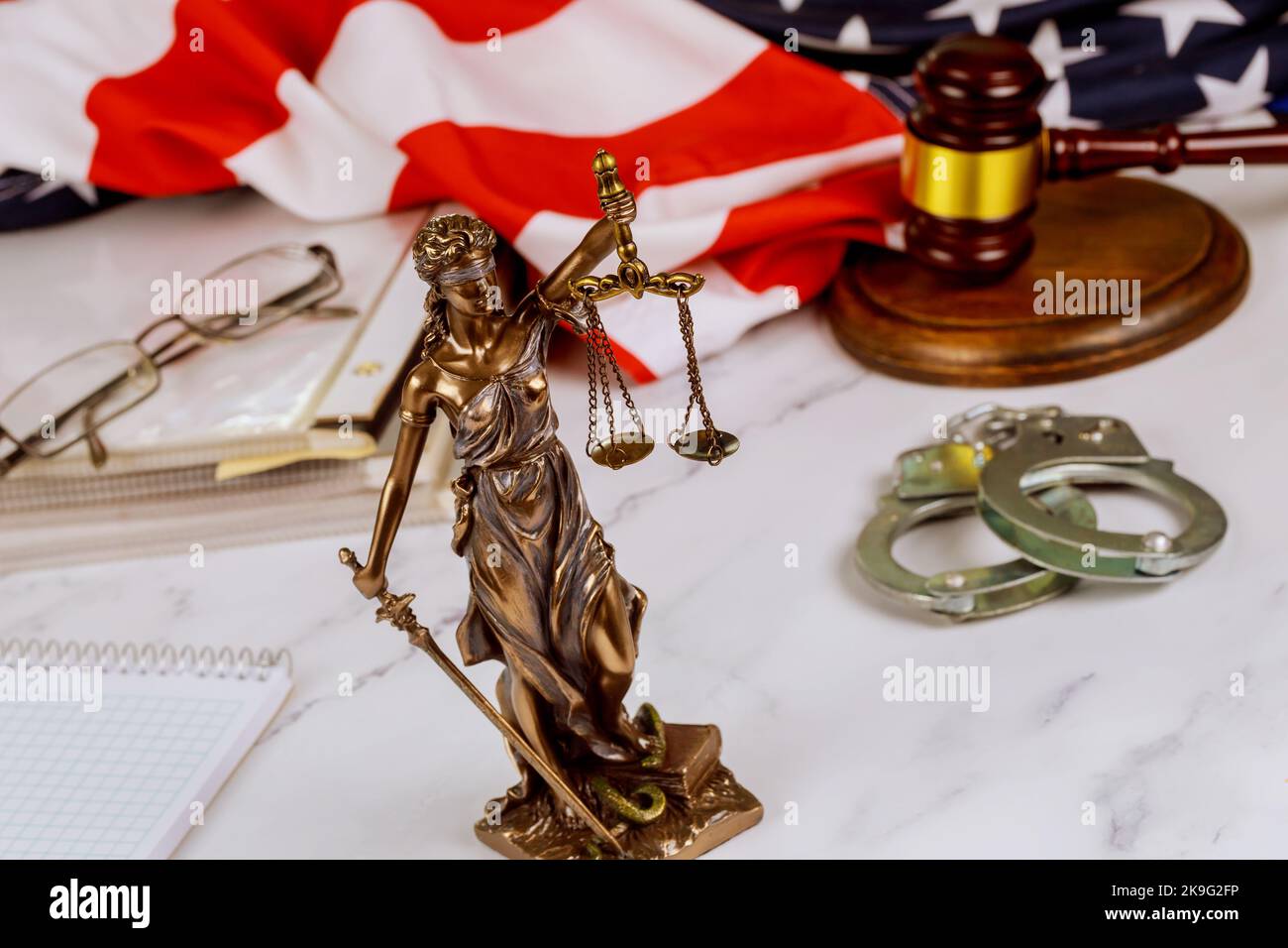 Standing at lawyer desk is statue Justice of Peace on law in court