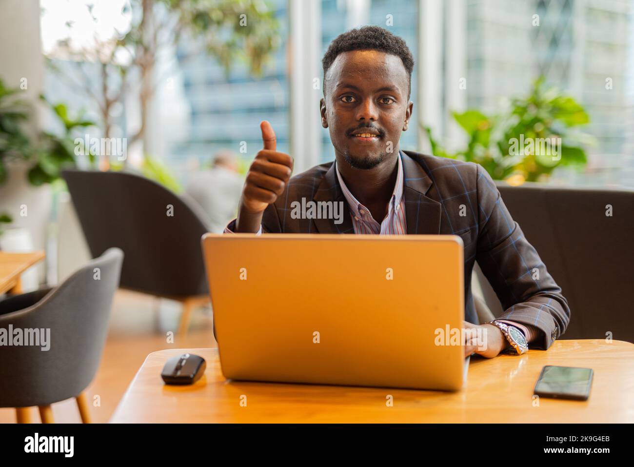 African businessman using laptop computer at coffee shop Stock Photo