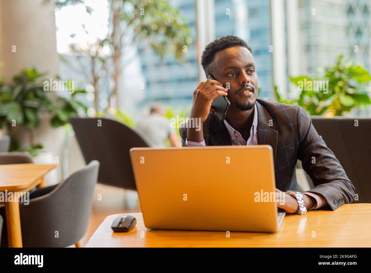 African businessman using laptop computer at coffee shop Stock Photo