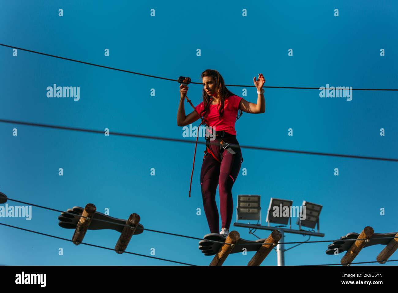 Woman Crossing Rope Aerial woman crossing rope bridge hi-res stock photography and images ...
