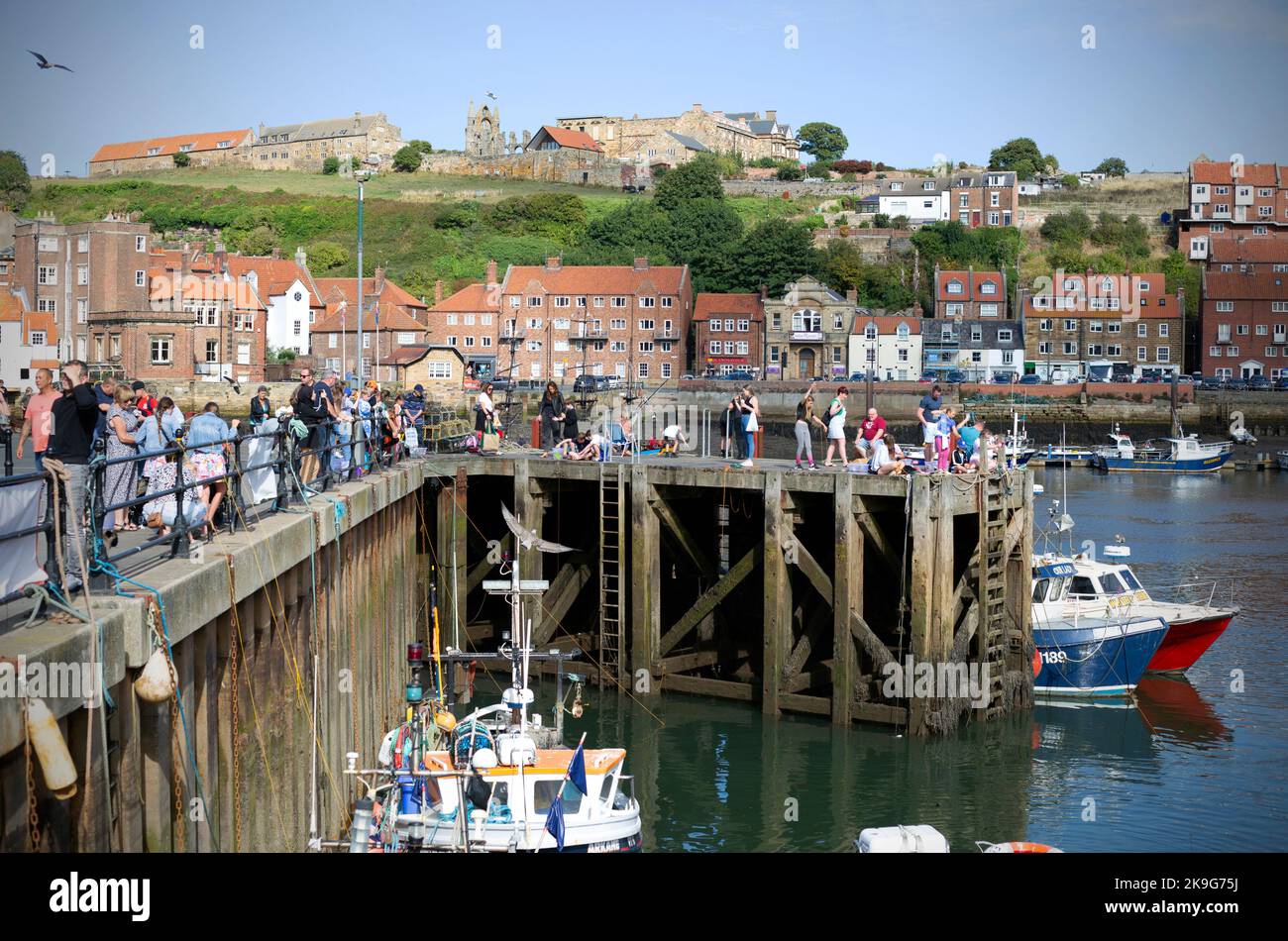 Pdeople “crabbing” in the seaside town of Whitby in North Yorkshire in Northern England. Stock Photo