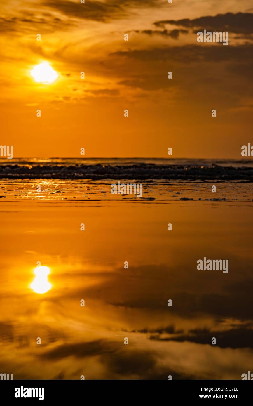 A golden sunset over the ocean with its reflection on the water Stock ...
