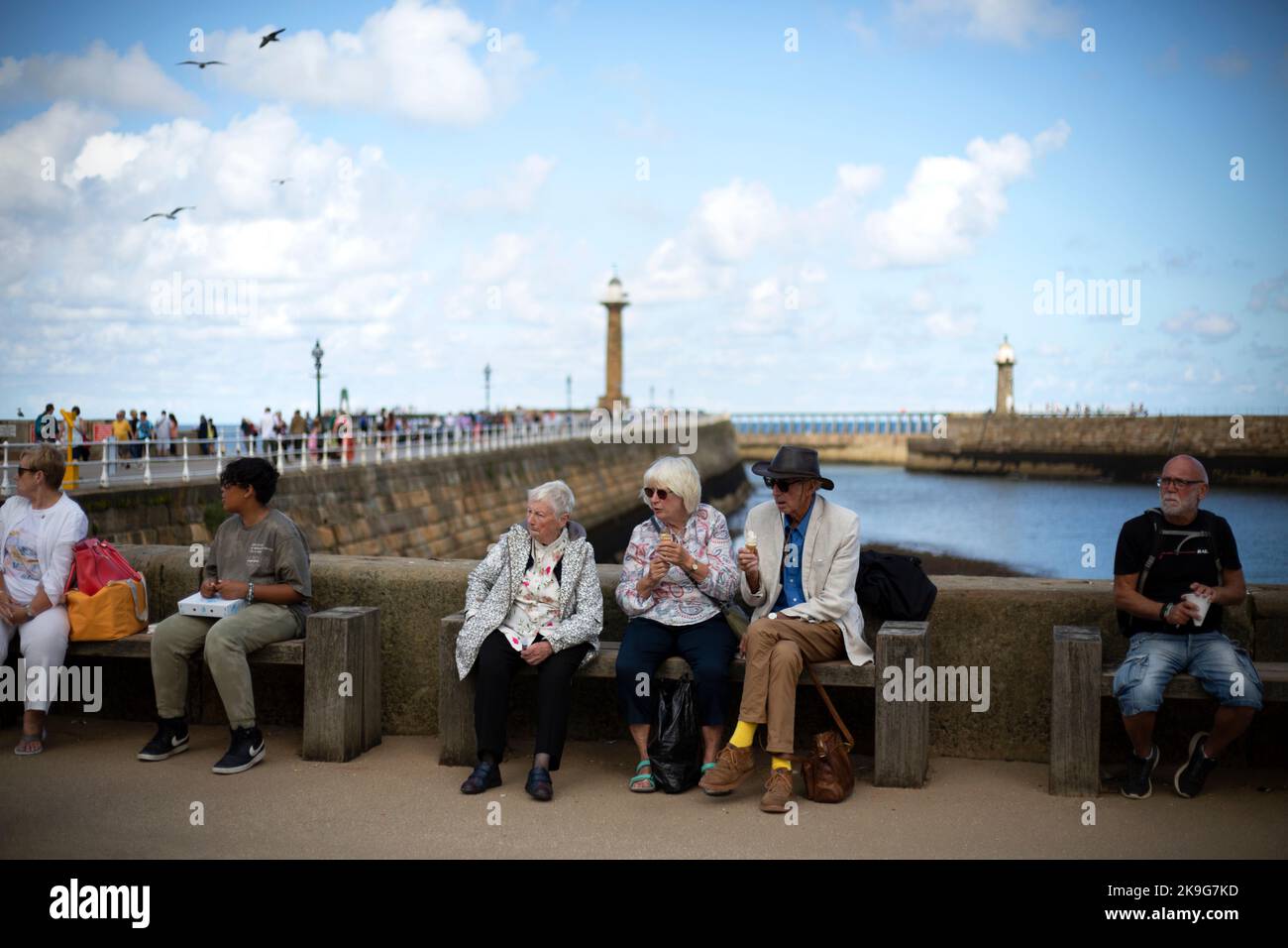 People eating ice cream in the seaside town of Whitby in North Yorkshire in Northern England. Stock Photo