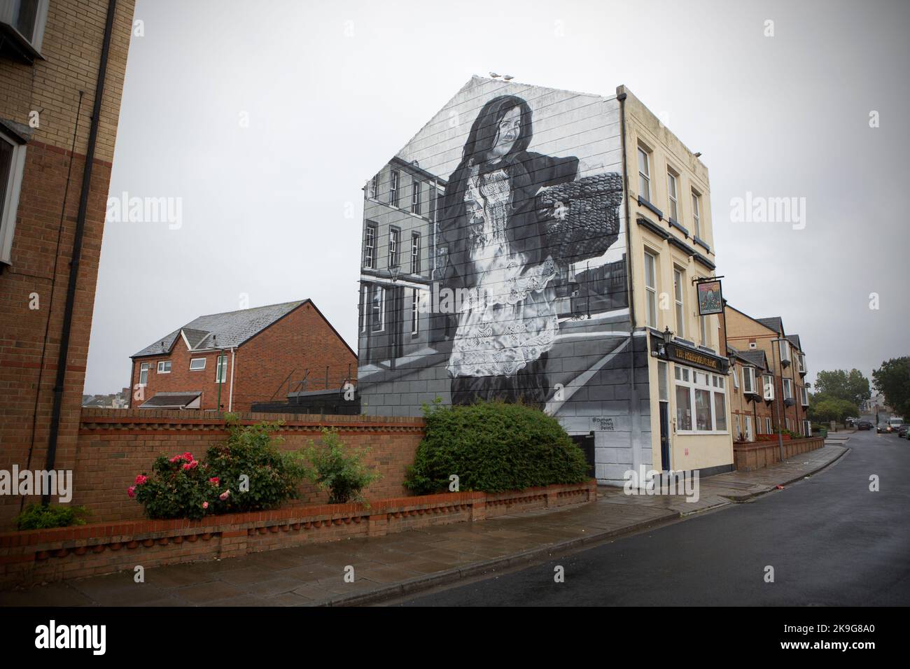 A mural on the side of a pub in the seaside port town of Hartlepool in County Durham. local fisherman and the community have suffered in the past year Stock Photo