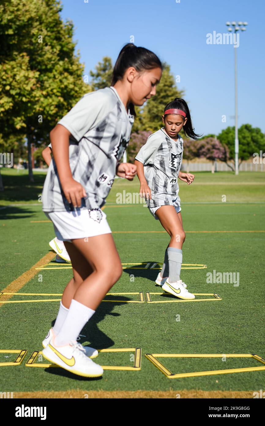 A girls youth soccer team training drills on the field in Southern California Stock Photo