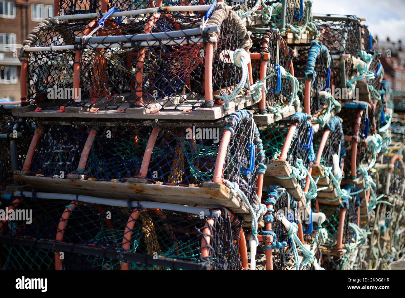 Lobster pots on the pier in the seaside town of Whitby in North Yorkshire in Northern England. local fisherman and the community have suffered in the Stock Photo