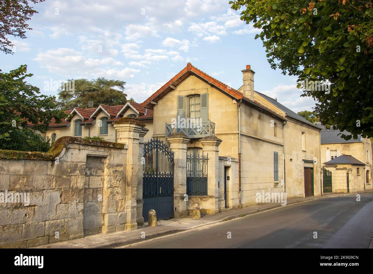 Vic-Sur-Aisne, France - Monday 25th July 2022: Road with beautiful stone buildings with warm golden light. High quality photo Stock Photo