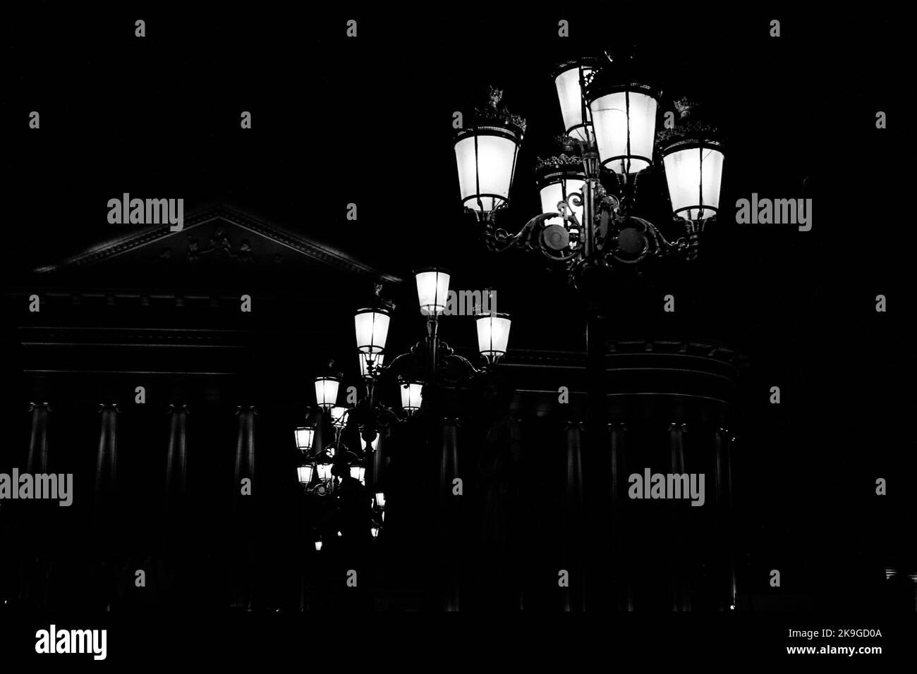 Lamp posts decorating the Bridge of Civilisations, in front of Archaeology Museum, Skopje, North Macedonia. Lit up at night, creating silhouette. Stock Photo