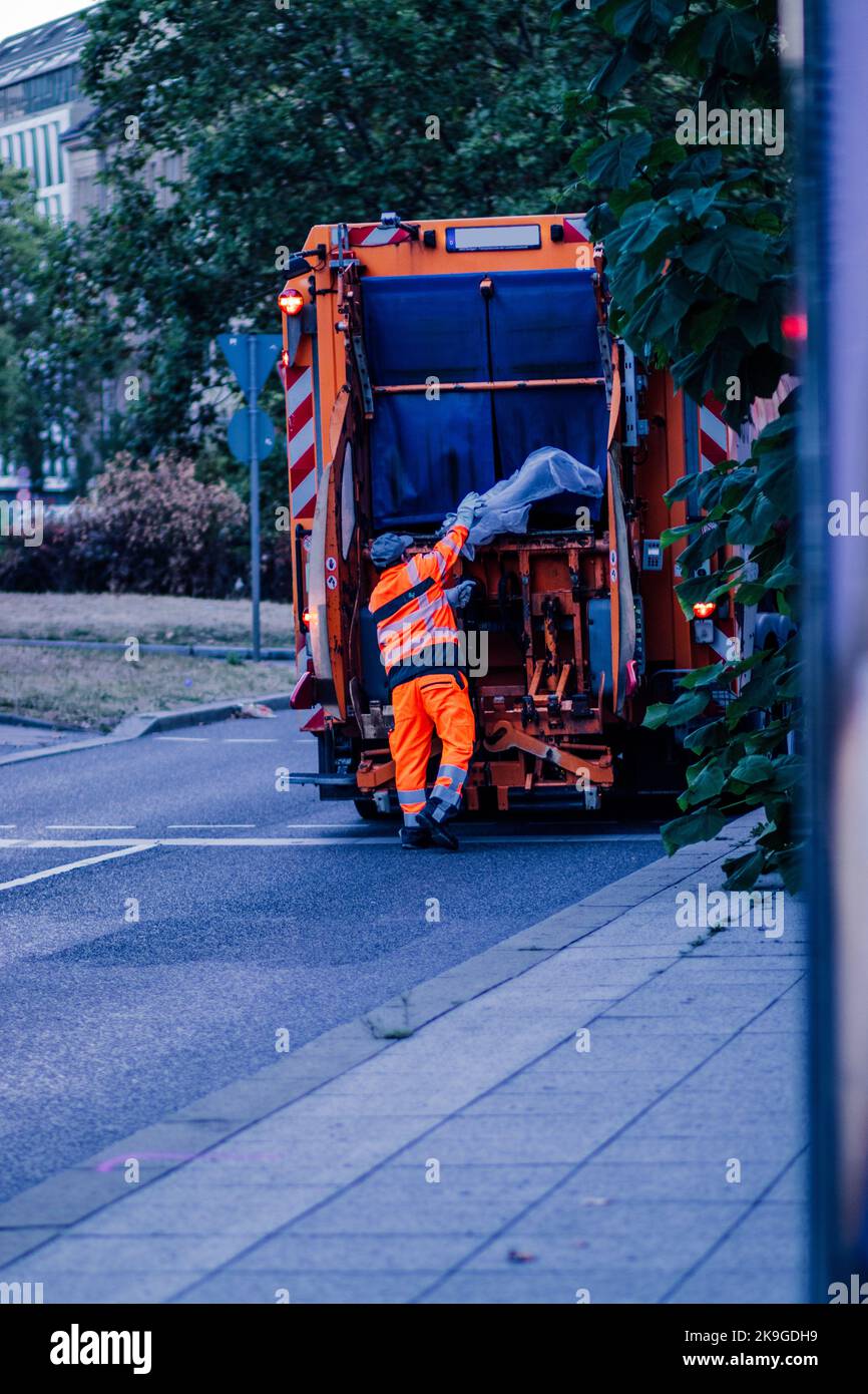 A garbage collection truck with a worker in Stuttgart, Germany Stock ...