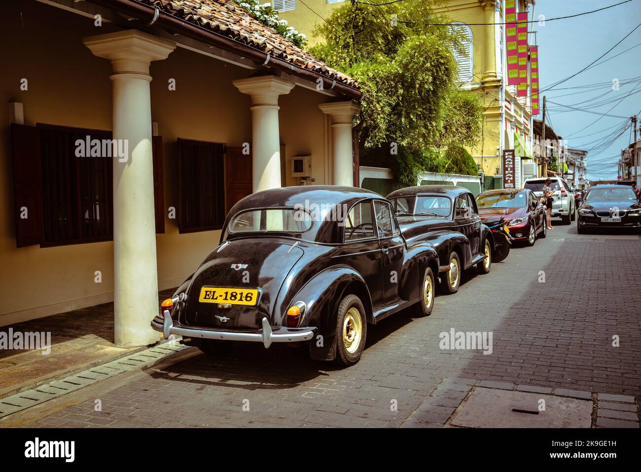 The view of the cars parked in the Dickwella street on a sunny day in Sri Lanka Stock Photo