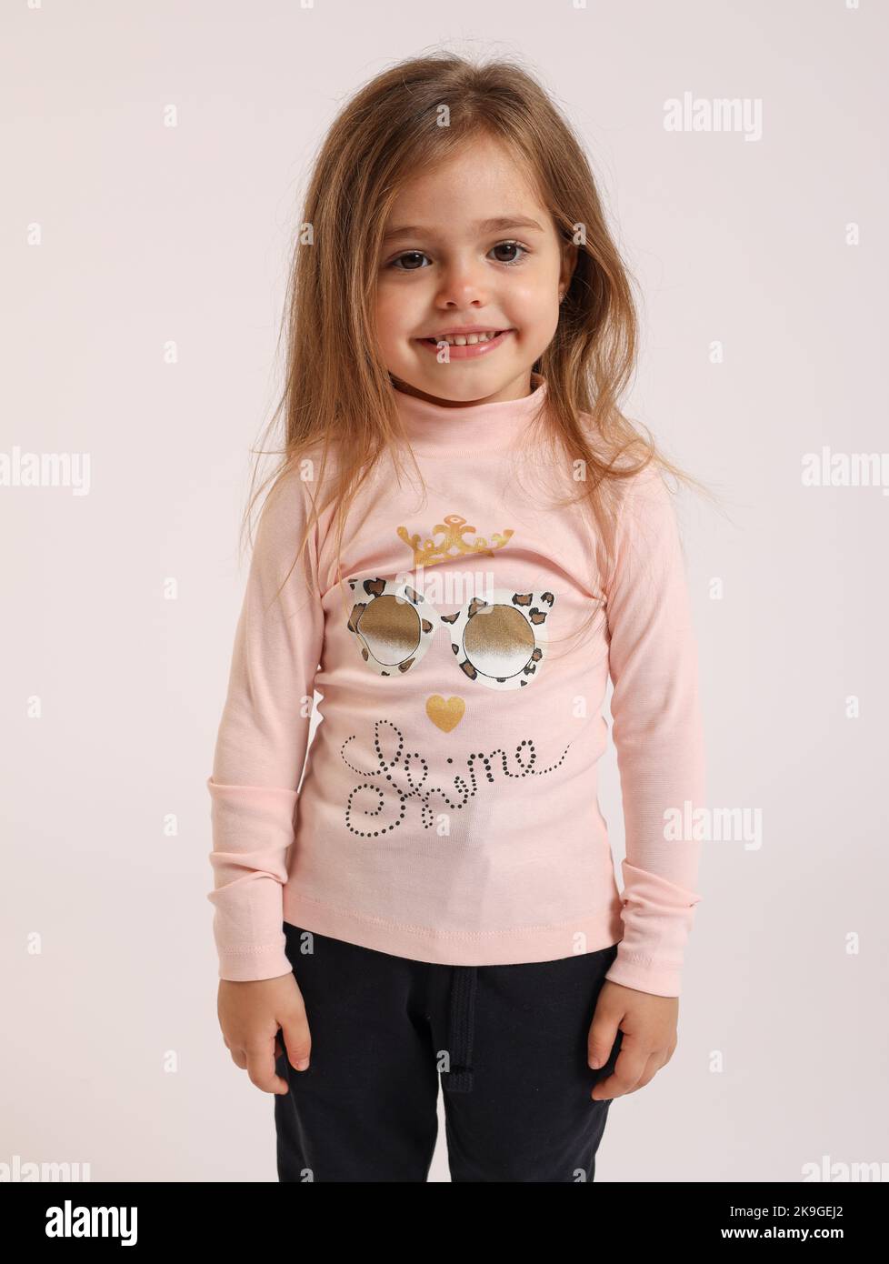 A little Caucasian girl posing on isolated white background Stock Photo ...