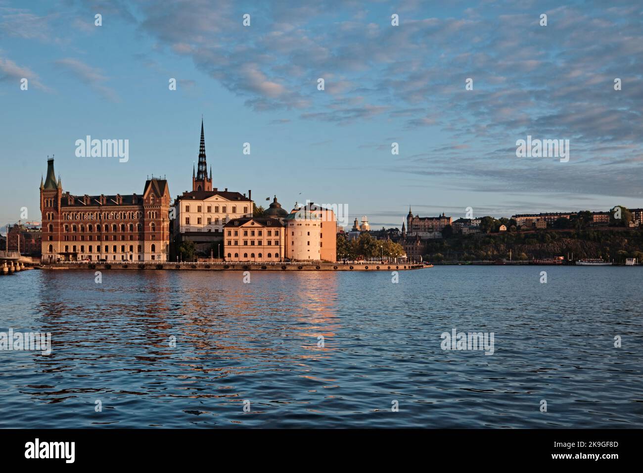 Stockholm, Sweden - Sept 2022: Riddarholm Church (Riddarholmskyrkan), Riddarholmen island and the old town at sunset skyline view from town hall water Stock Photo