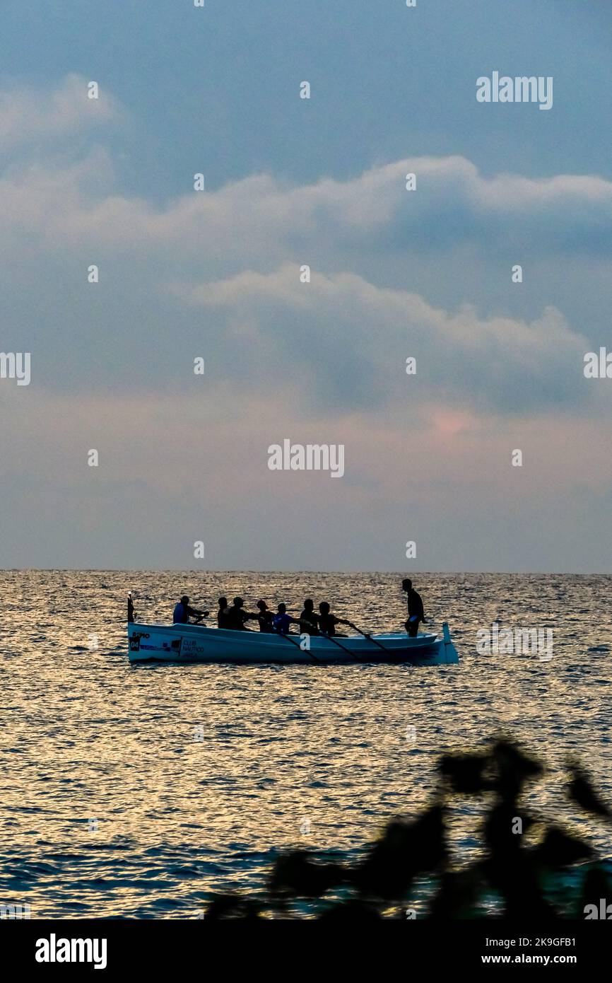 A vertical shot of the boat with rowers under the blue sky Stock Photo ...