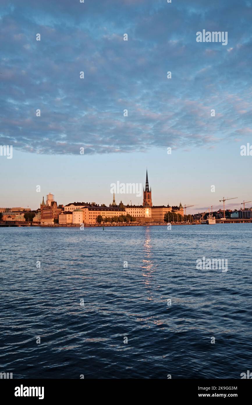 Stockholm, Sweden - Sept 2022: Riddarholm Church (Riddarholmskyrkan), Riddarholmen island and the old town at sunset skyline view from town hall water Stock Photo