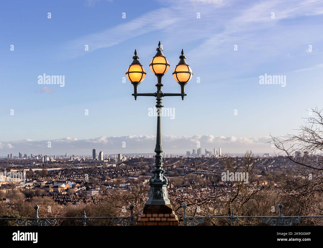 A view across London from the top of Alexandra Palace.In the foreground is one of the many lamp stands with intricate glass and lit even in the day. Stock Photo