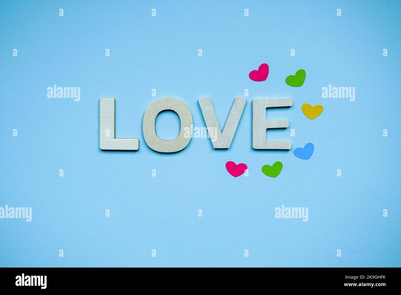 love wooden letters and heart shapes on the blue background for ...