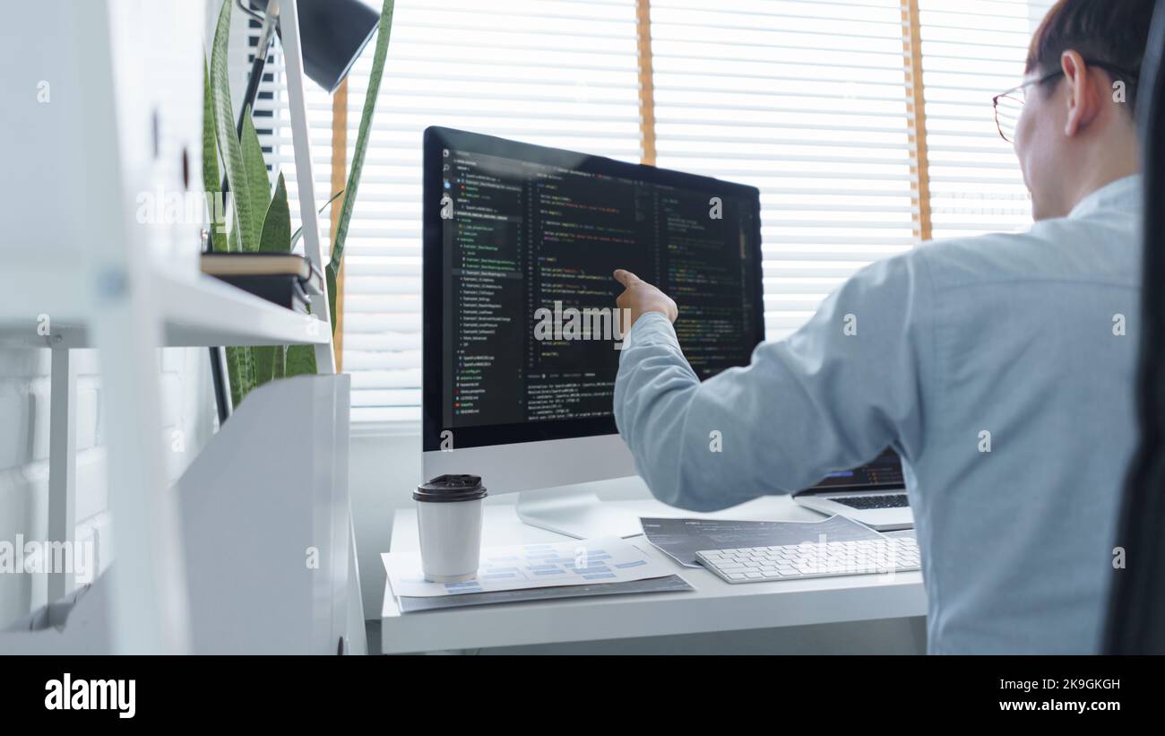 Software development concept, Male programmer checking data codes on ...