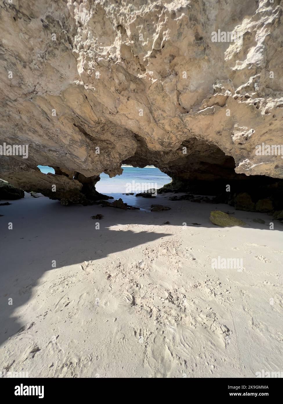 A vertical shot of rocky cliffs on the beach Stock Photo - Alamy