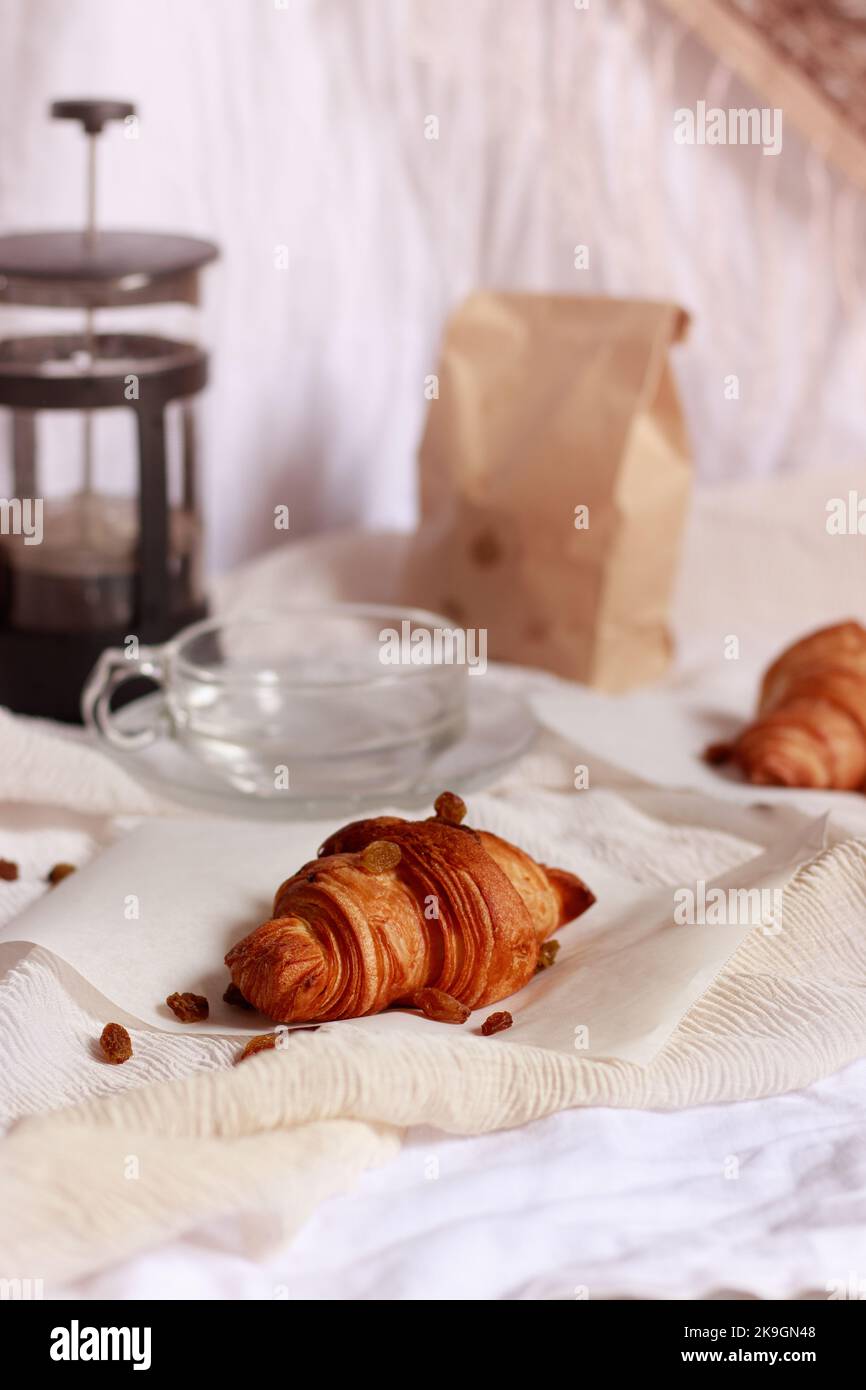 French press coffee maker and freshly baked croissant Stock Photo