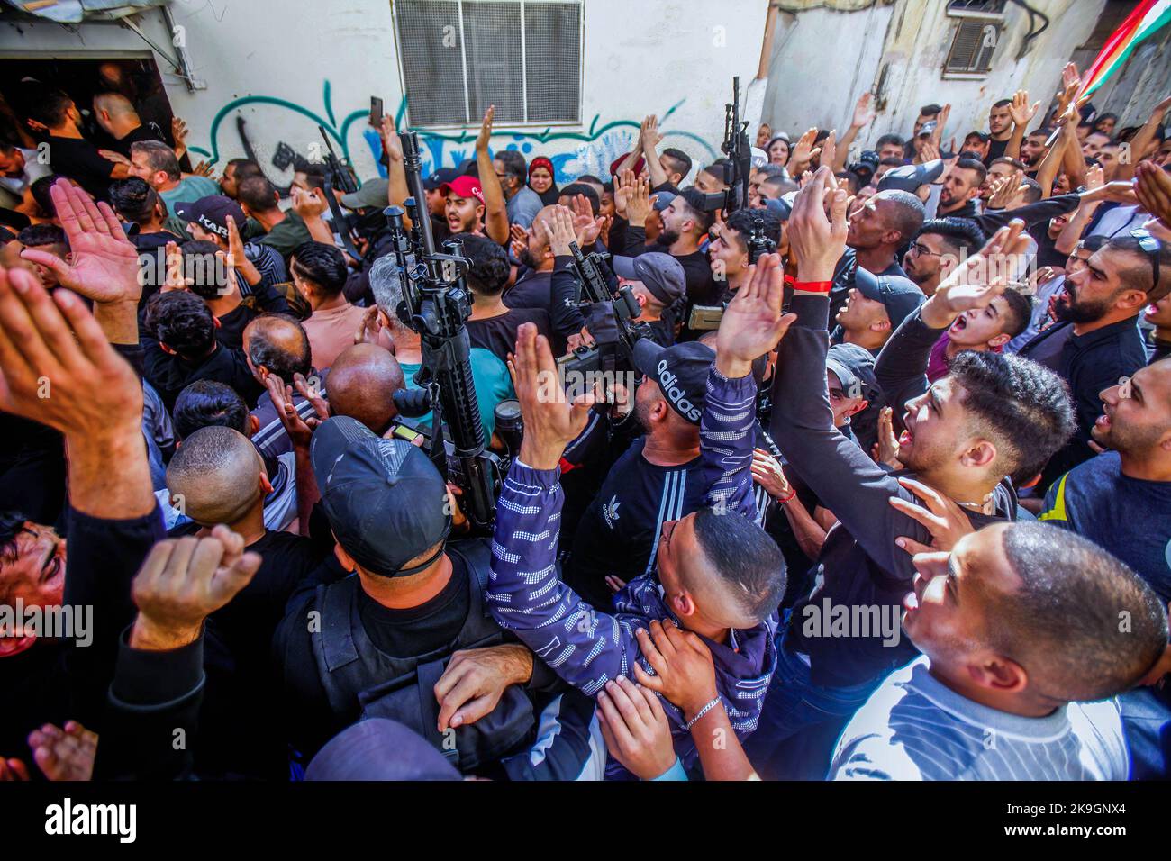 Mourners and gunmen chant slogans during the funeral of the ...
