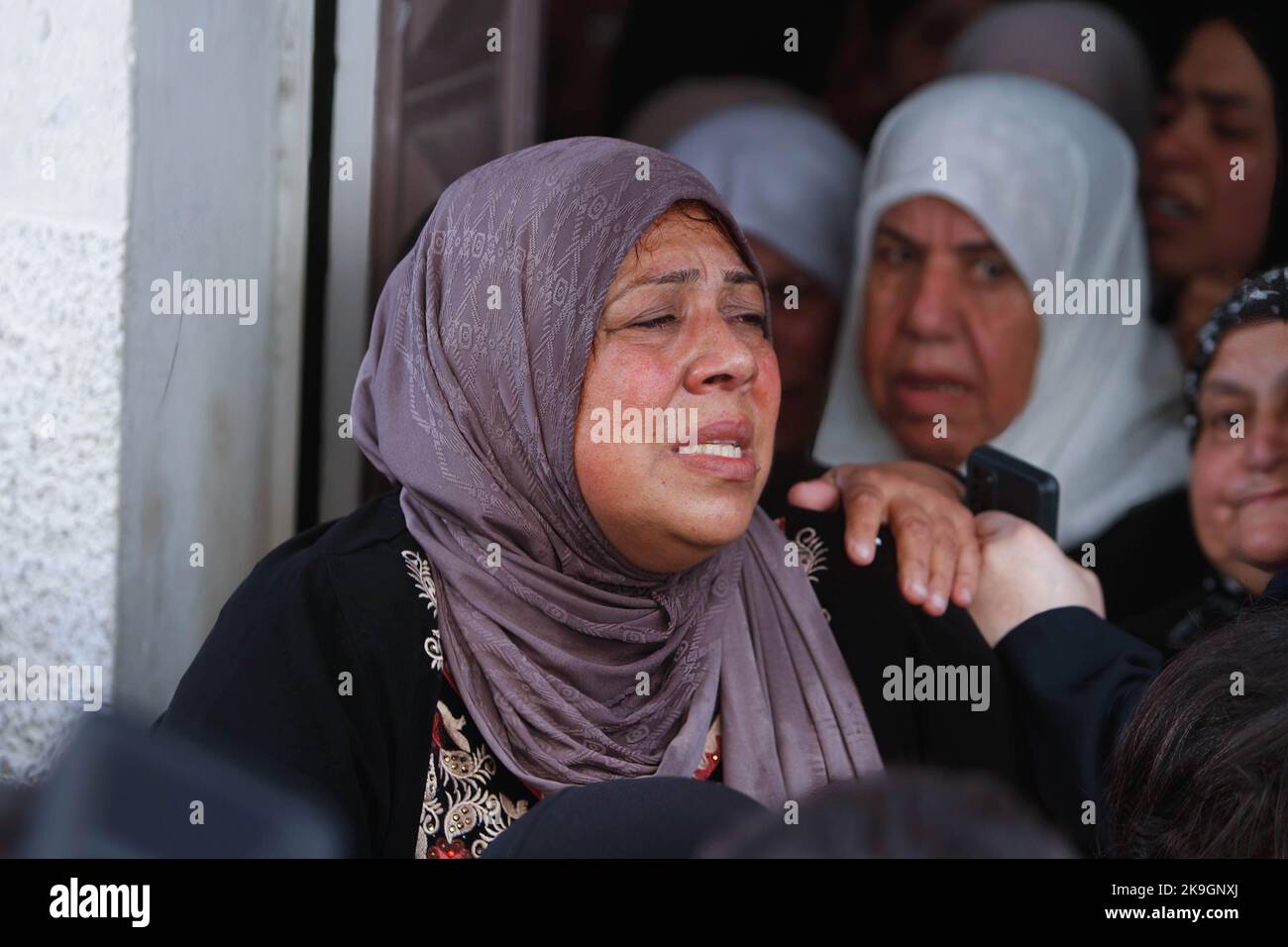 A relative mourns during the funeral of the Palestinians Imad Abu ...