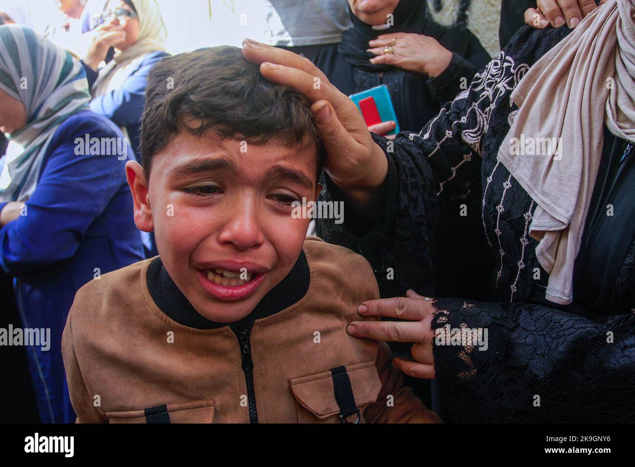 A young relative mourns during the funeral of the Palestinians Imad Abu ...