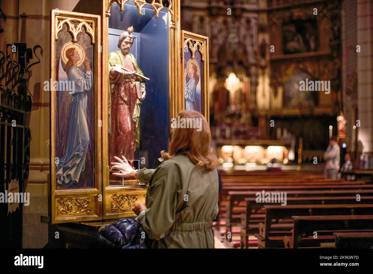 A woman prays and her right hand touches the interior of the image of San Judas Tadeo inside the Santa Cruz Church in central Madrid during the celebration of the day of San Judas Tadeo. Every October 28th, the day of San Judas Tadeo is celebrated, patron saint of lost and difficult causes. In the centre of Madrid, on Atocha street, the church of Santa Cruz is located, which houses the image of San Judas Tadeo to which thousands of Catholic believers come to touch it and ask for its prayers. (Photo by Luis Soto/SOPA Images/Sipa USA) Stock Photo