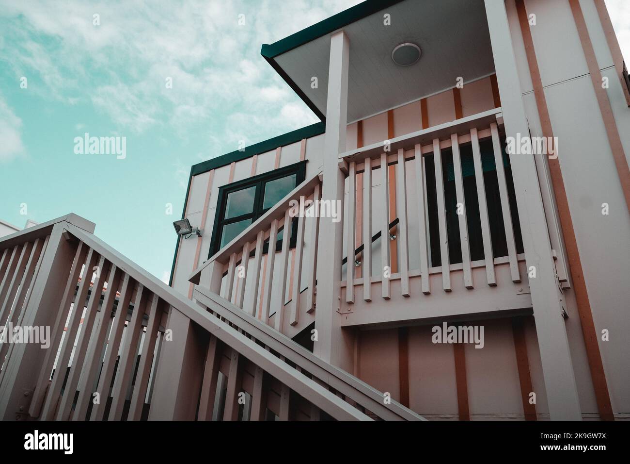 staircase with wooden railing in nice old white house with square ...