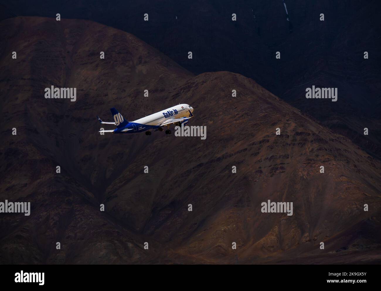 Ladakh, India - June 19, 2022 : Go Air, indian passenger plane fly up from Leh airport surrounded by Himalaya mountain range Stock Photo