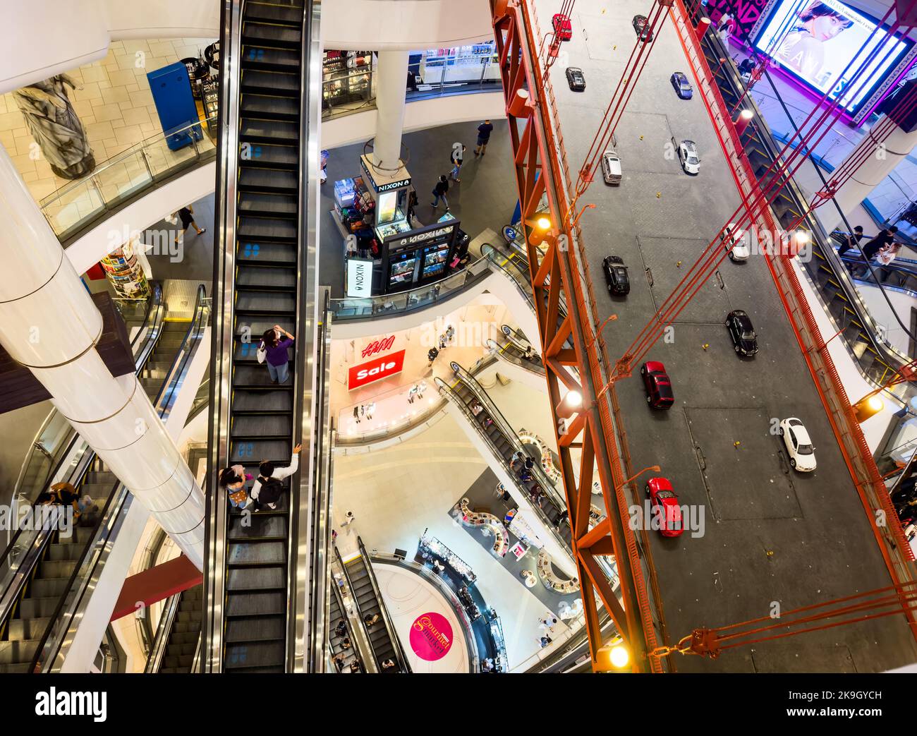 People ride the escalators next to a model of the Golden Gate Bridge in the modern Pier 21