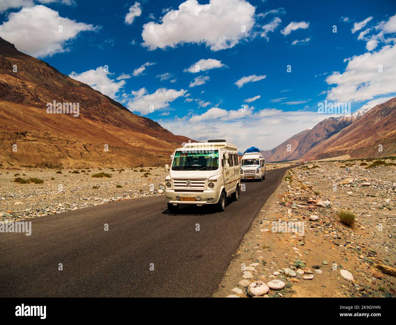 Leh, India - June 18, 2022: Tempo Traveller, highly used tourist vehicle on Mountain road of Ladakh, Northern India.Beautiful landscape of Ladakh, hig Stock Photo
