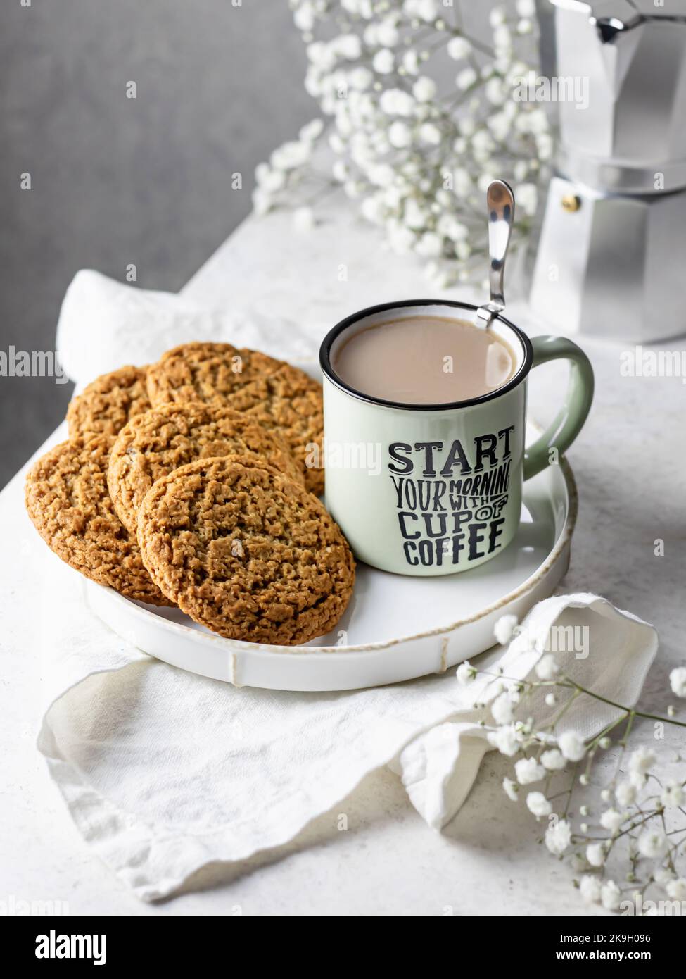 Mug of hot coffee with homemade oatmeal cookies. Home warmth and comfort in autumn morning concept. Autumn still life Stock Photo