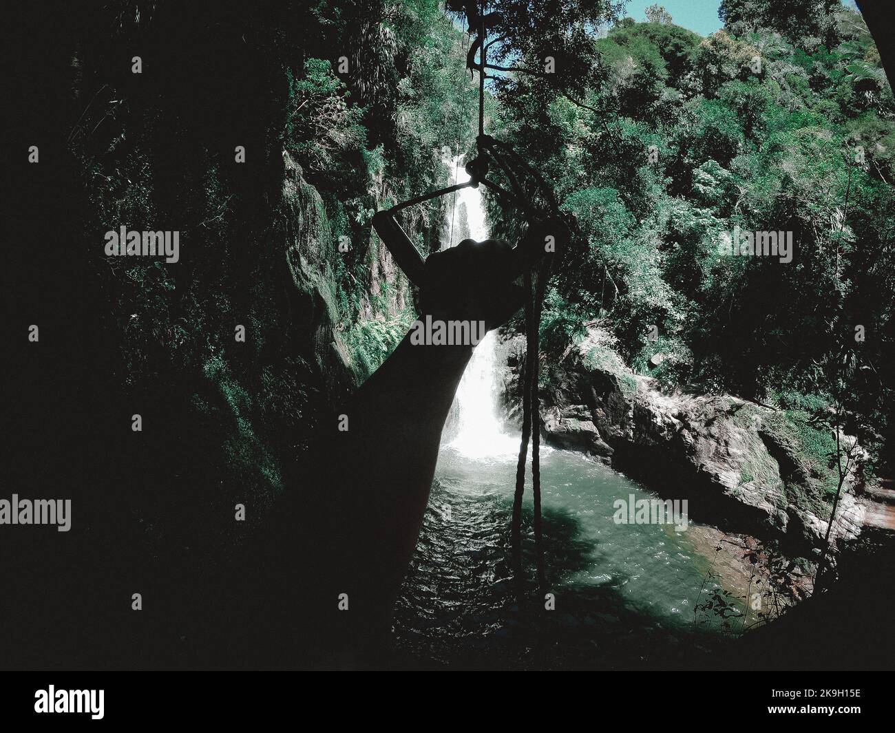 Outstretched hand holding a rope in a waterfall Stock Photo - Alamy