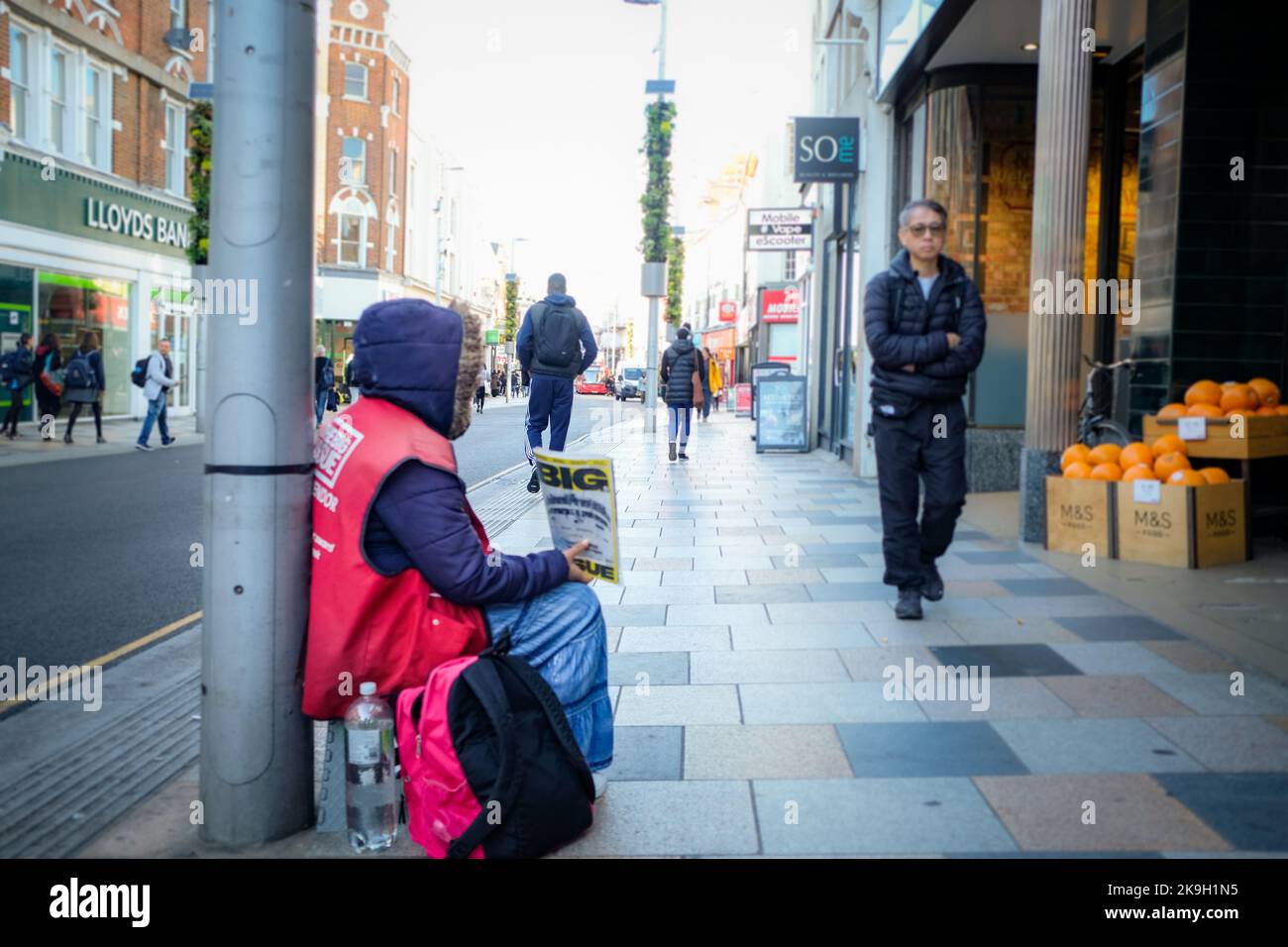 London- October 2022: A homeless person selling Big Issue magazines on Northcote Road, Clapham in south west London Stock Photo
