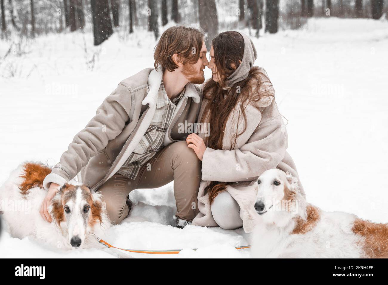Love romantic young couple girl, guy in snowy cold winter forest ...