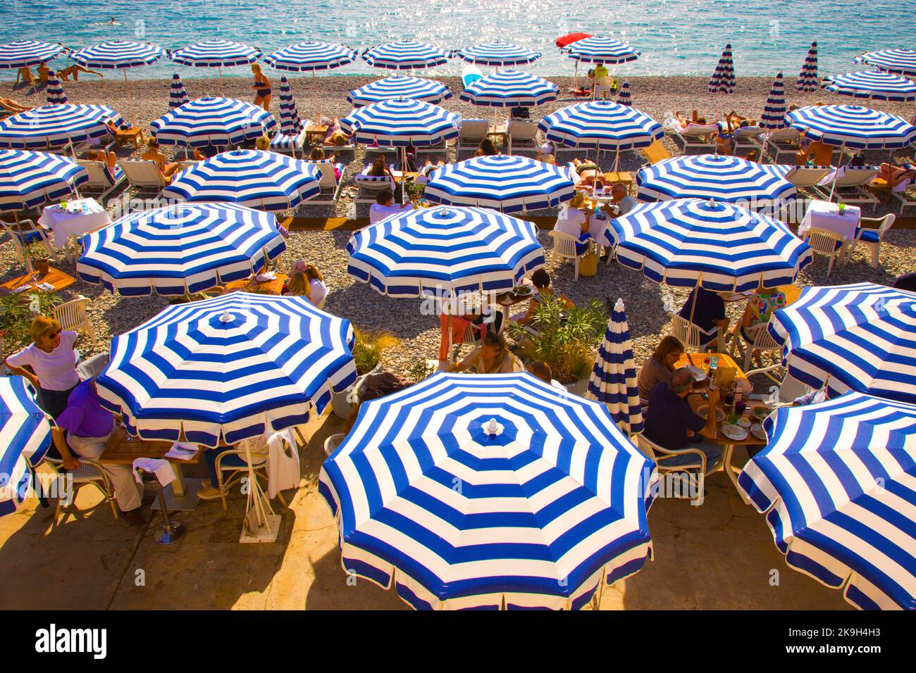 France, Cote d'Azur, Nice, beach, umbrellas, Promenade des Anglais, Stock Photo